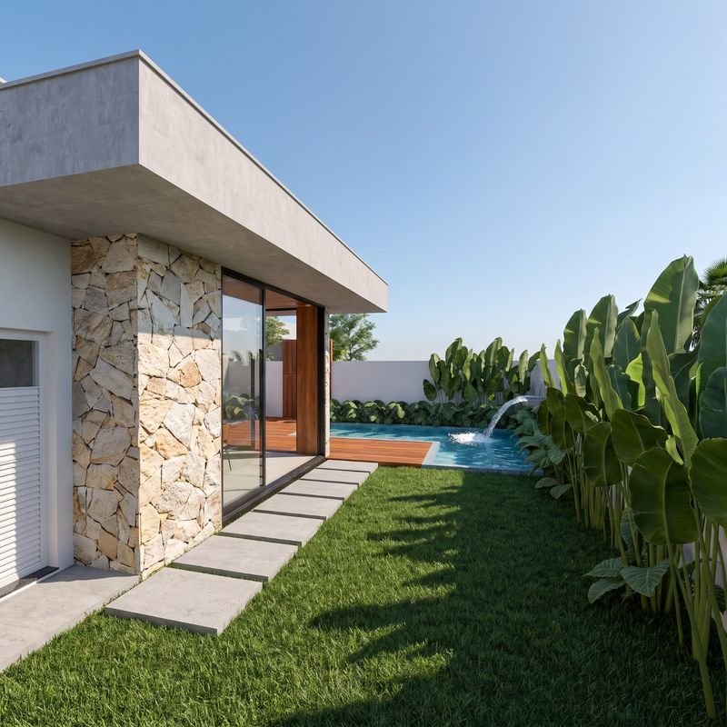 Jardim lateral com caminho de placas, paisagismo tropical e piscina com cascata ao fundo (projeto) — casa de alto padrão à venda no Cadorin, Pato Branco